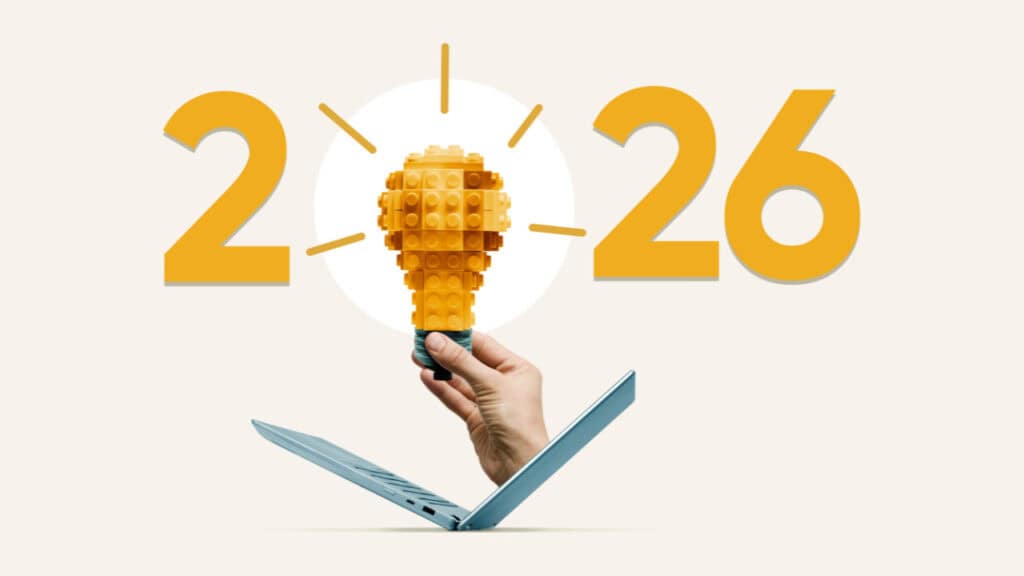 L&D in 2026 - A hand emerging from an open laptop holds a yellow LEGO-style lightbulb, with the numbers ‘2026’ on either side, symbolizing innovation in the digital future.